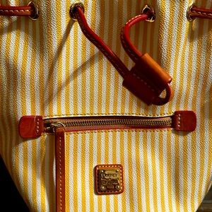 Dooney&Bourke small Bucket Bag. Yellow&White, with feet.